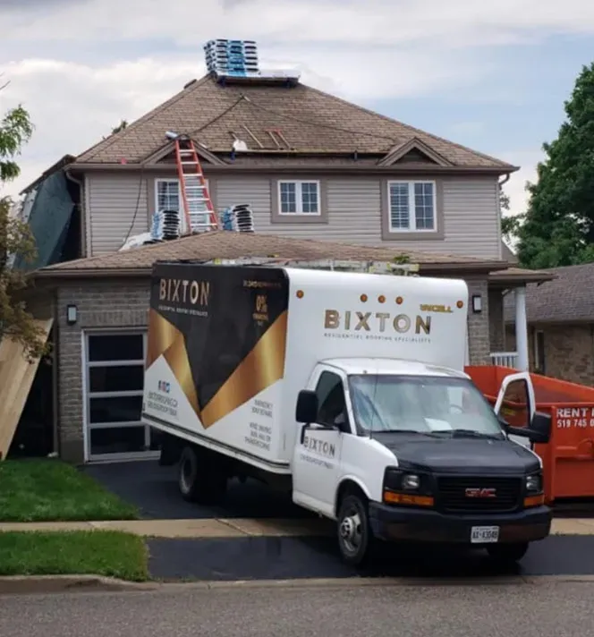 Bixton work truck parked in the driveway of a two-storey home during a roof replacement